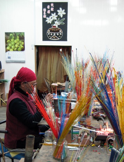 A glass-bead artisan at work in Sandimen, Tawian