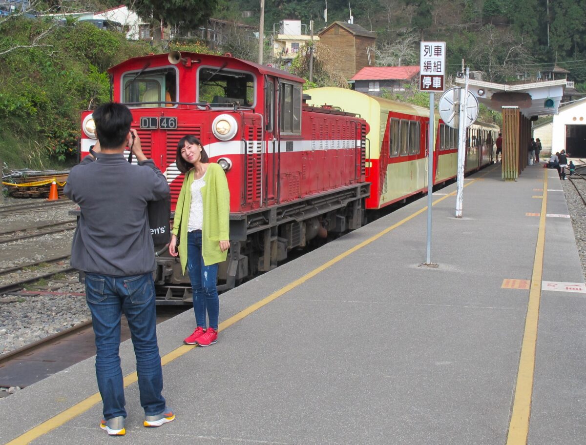 Tourists take photos with the Alishan train at Fenqihu, Taiwan.